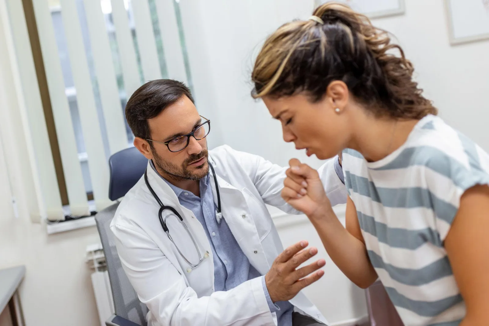 Doctor consulting with a patient about respiratory symptoms