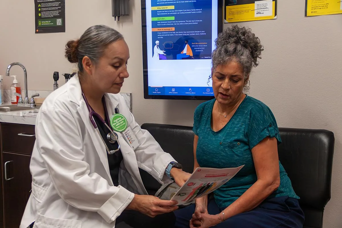 Pharmacist and physician discussing prescribing data